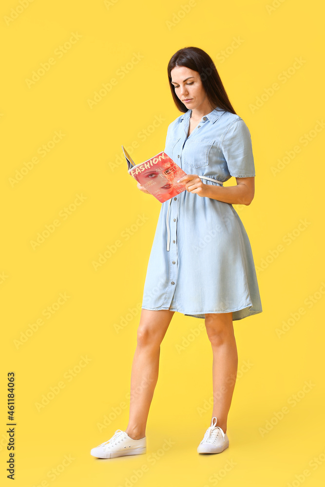 Beautiful young woman with magazine on color background Beautiful young woman with magazine on color background