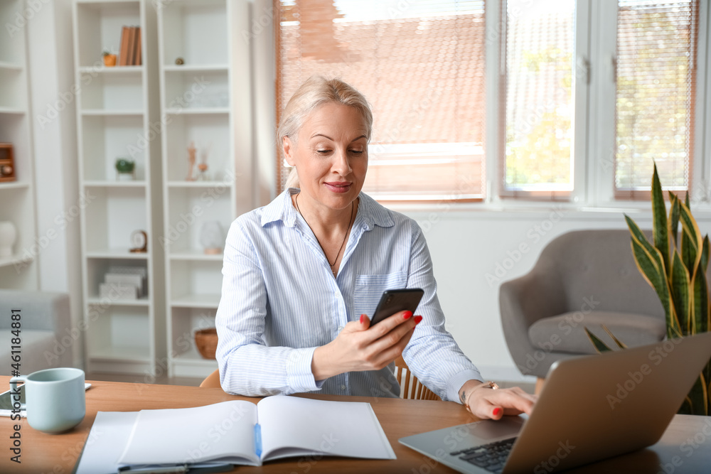 Mature woman working in office Mature woman working in office
