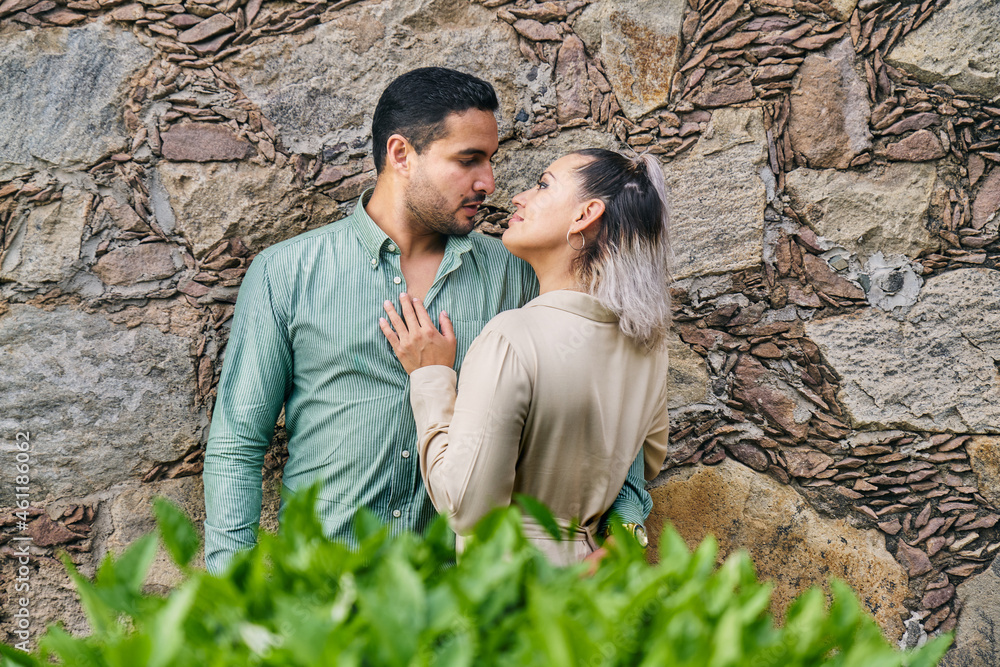 Young latin male and female couple looking at each other in love between 25 and 35 years old Young latin male and female couple looking at each other in love between 25 and 35 years old