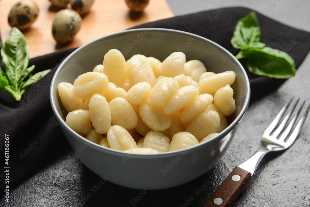 Bowl with tasty gnocchi on dark background Bowl with tasty gnocchi on dark background