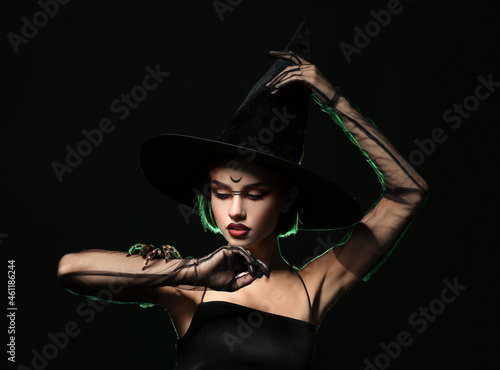 Young witch with spider on ...