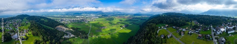 Aerial view around austria of the village Schellenberg in Liechtenstein on an early morning day in summer.	