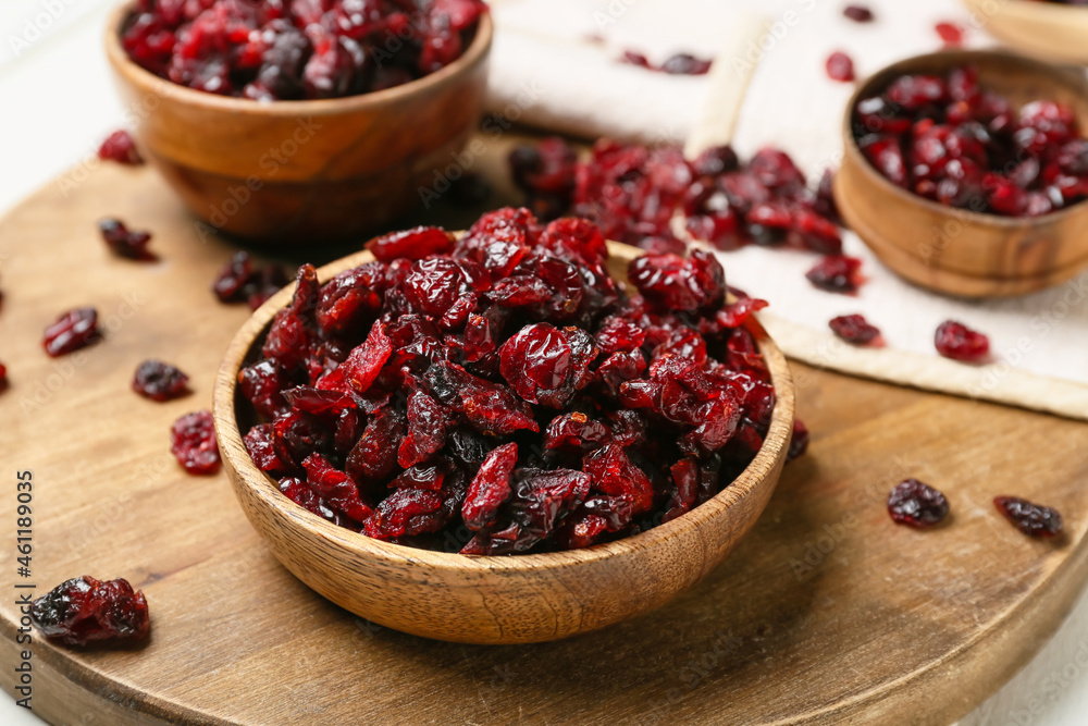 Bowl with tasty dried cranberries on table, closeup Bowl with tasty dried cranberries on table, closeup