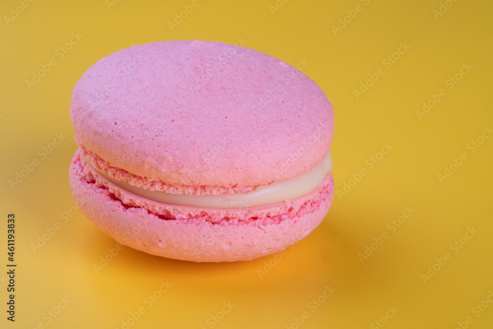 Close-Up Of Cookie Macoron on yellow background with copy space. Close-Up Of Cookie Macoron on yellow background with copy space.