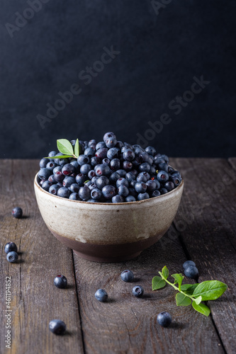 Blueberry bowl on wooden background with copy space in rustic style
