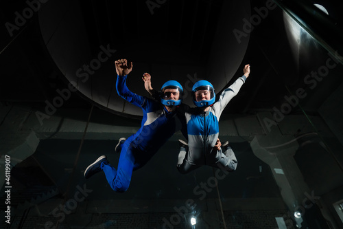 A man and a woman enjoy flying together in a wind tunnel. Free fall simulator