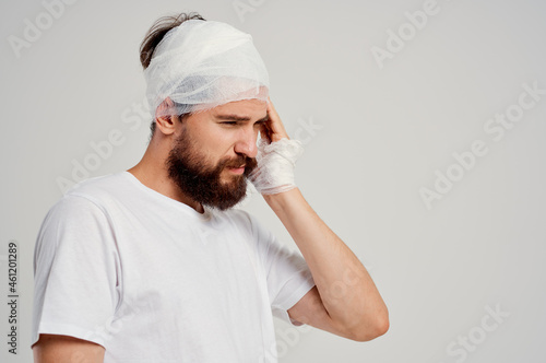 Man bandaged head and hand blood treatment