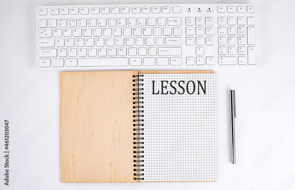 LESSON text on the notebook with keyboard on the white background LESSON text on the notebook with keyboard on the white background