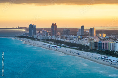 Aerial view of Miami skyline and tall skyscrapers from helicopter at sunset. © jovannig