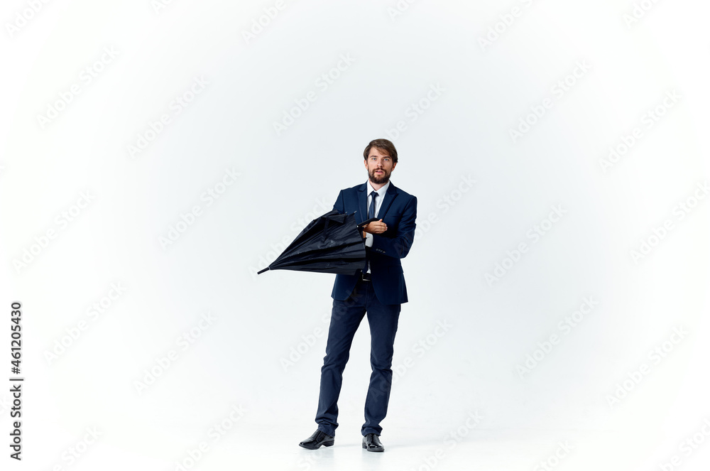 business man in a suit holding an umbrella elegant style protection from the rain business man in a suit holding an umbrella elegant style protection from the rain