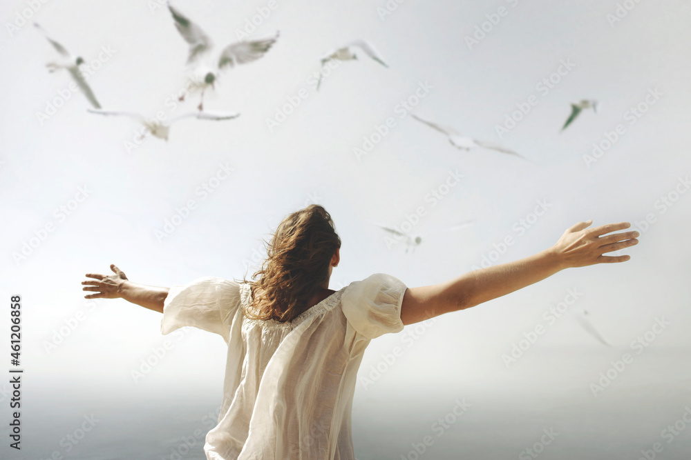 woman with open arms towards the sky breathes an air of freedom - obrazy, fototapety, plakaty 