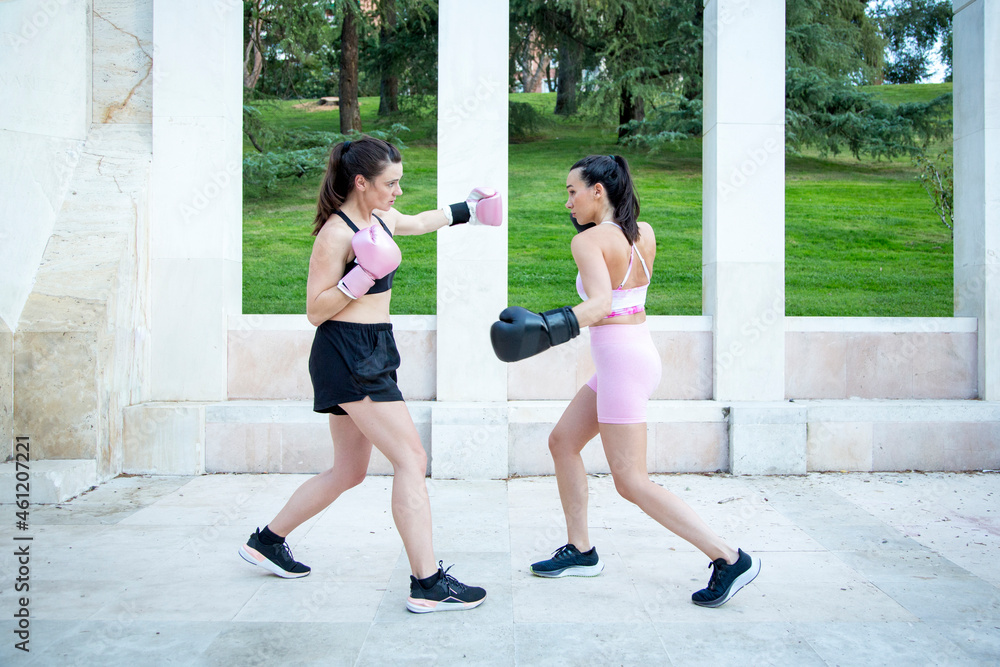 boxing match between two young caucasian women outdoor