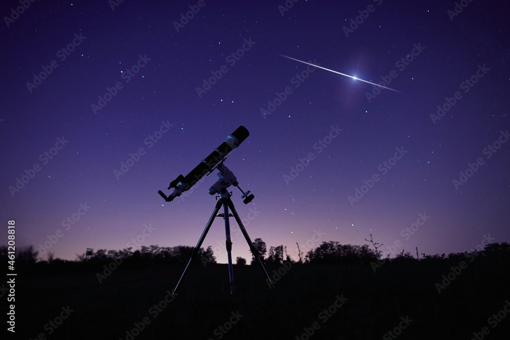 Silhouette of a telescope and countryside under the starry skies.