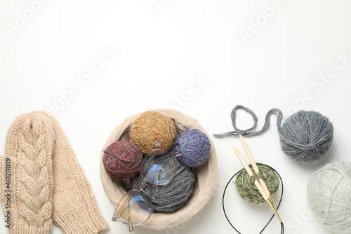 Knitting concept with yarn balls on white background