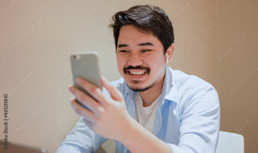 close up young middle eastern man sitting at the coffee cafe and using video call form smartphone to talking with friends and family for new normal and healthy lifestyle concept close up young middle eastern man sitting at the coffee cafe and using video call form smartphone to talking with friends and family for new normal and healthy lifestyle concept