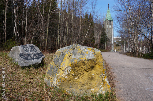 Road leads to the temple (Église Sainte-Amélie de Baie-Comeau), roadside stones. Province of Quebec, Canada. Baie-Comeau, Canada. photo