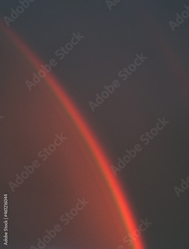 abstract natural background. A rainbow on a dark stormy sky at sunset.