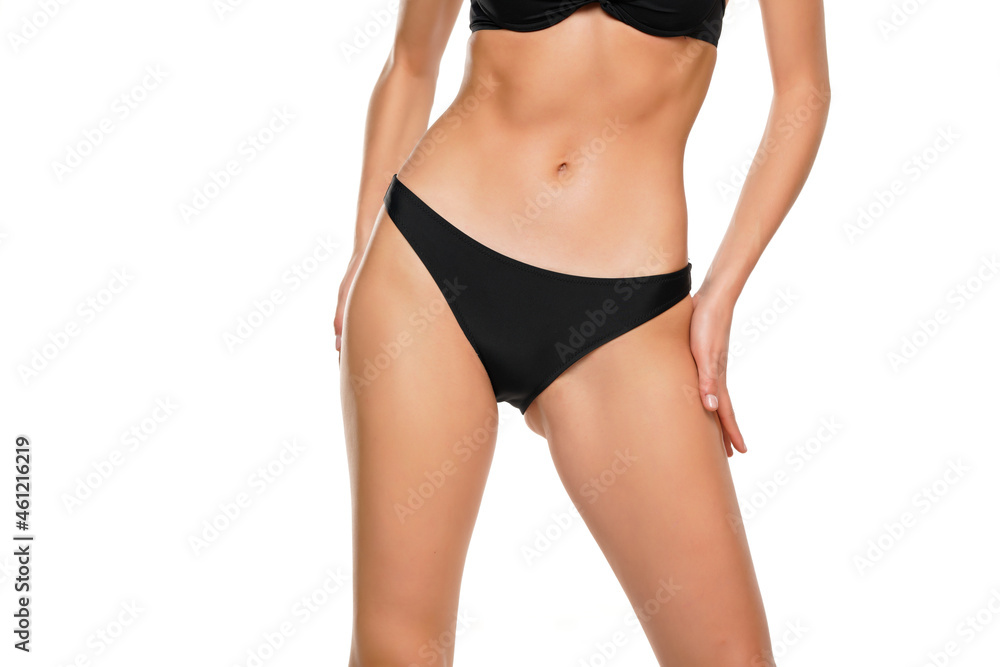 a woman applies cream to her thigh and hips a woman applies cream to her thigh and hips