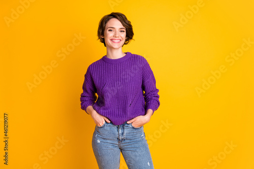 Wallpaper Mural Portrait of lovely content cheerful girl posing holding hands in pockets isolate