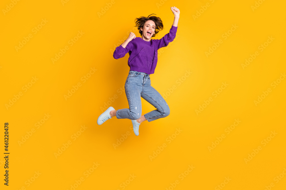 Full length body size view of attractive lucky cheerful girl jumping rejoicing yeah isolated over bright yellow color background