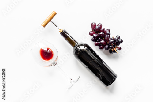 Wine in glass and bottle with corks and grape