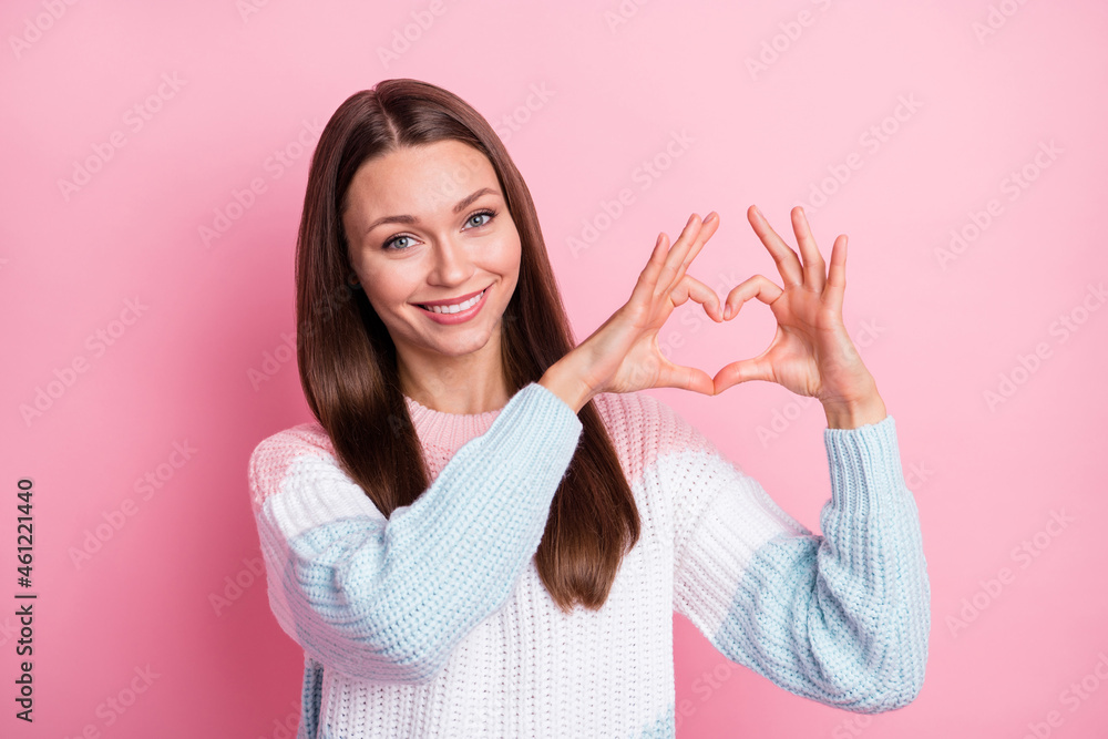 Photo portrait of lovely nice girl showing heart with fingers on date  smiling isolated on pastel pink color background Photos | Adobe Stock