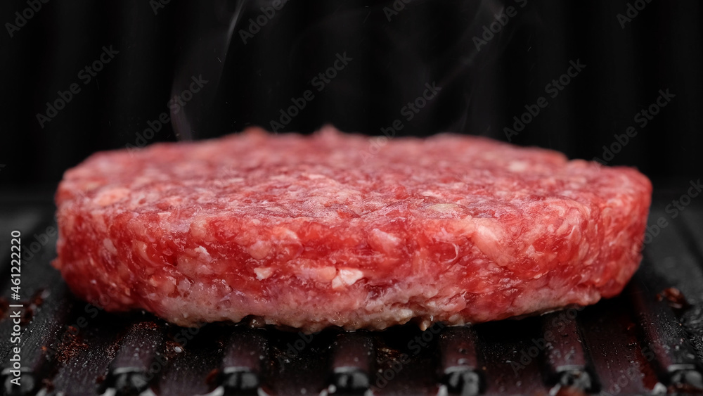 Grilling beef patty for burger close up. Making Tasty Hamburger Grilling beef patty for burger close up. Making Tasty Hamburger
