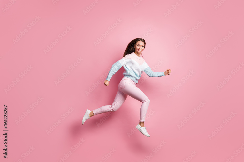 Full body profile side photo of attractive active young woman run jump up isolated on pastel pink color background