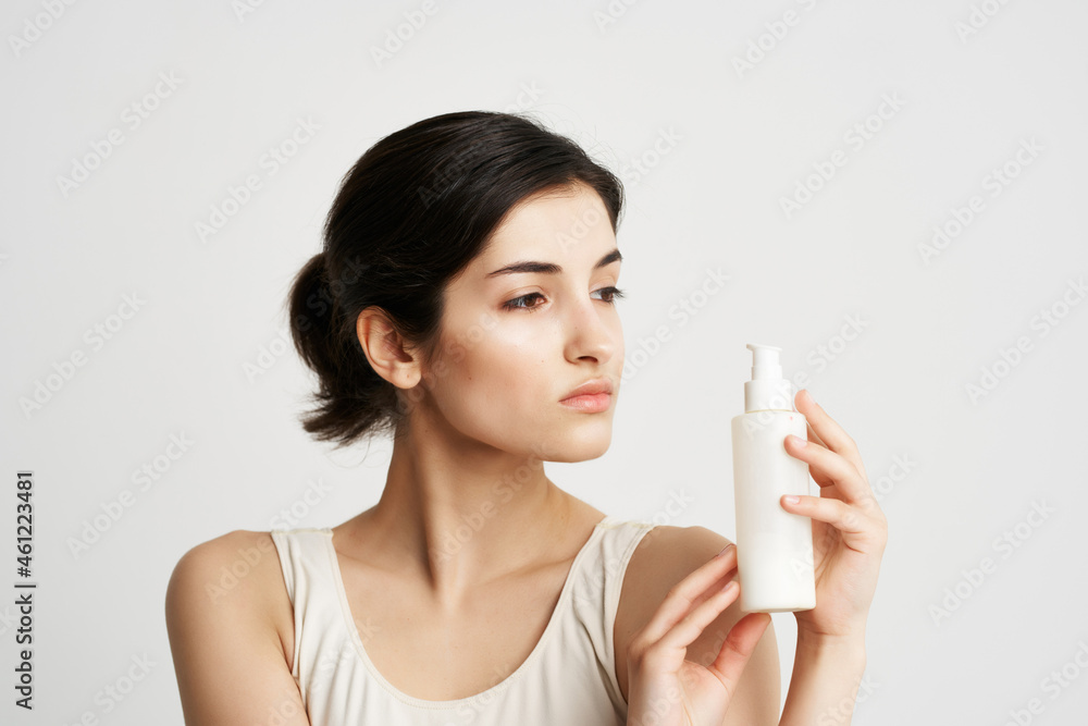 pretty brunette in white tank top cream skin moisturizing cosmetics pretty brunette in white tank top cream skin moisturizing cosmetics