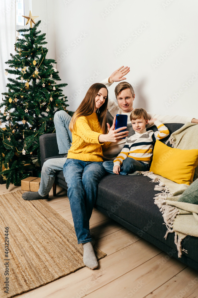 Obraz premium Happy family in sofa, yellow gray colors.