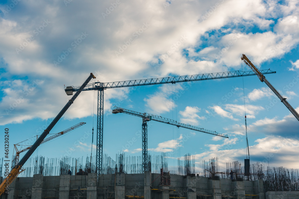 construction cranes on the background of blue sky construction cranes on the background of blue sky
