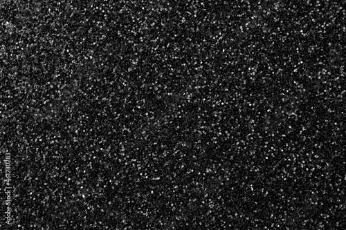 Black glitter texture background, glitter or sandpapper high detailed surface, shining glowing effects concept