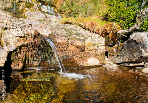 The small Kroelvi stream of Tvindefossen  waterfall, Norway photo
