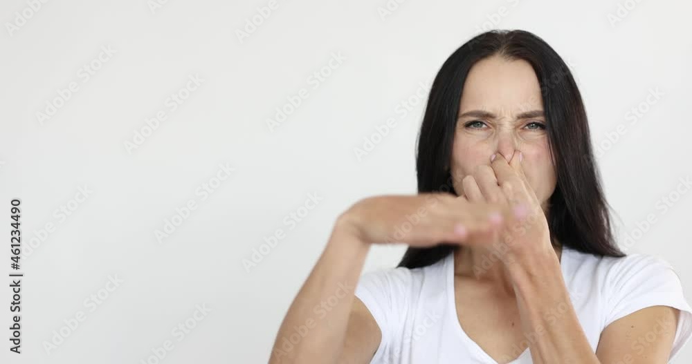 Young woman covering nose and waving hand 4k movie Young woman covering nose and waving hand 4k movie