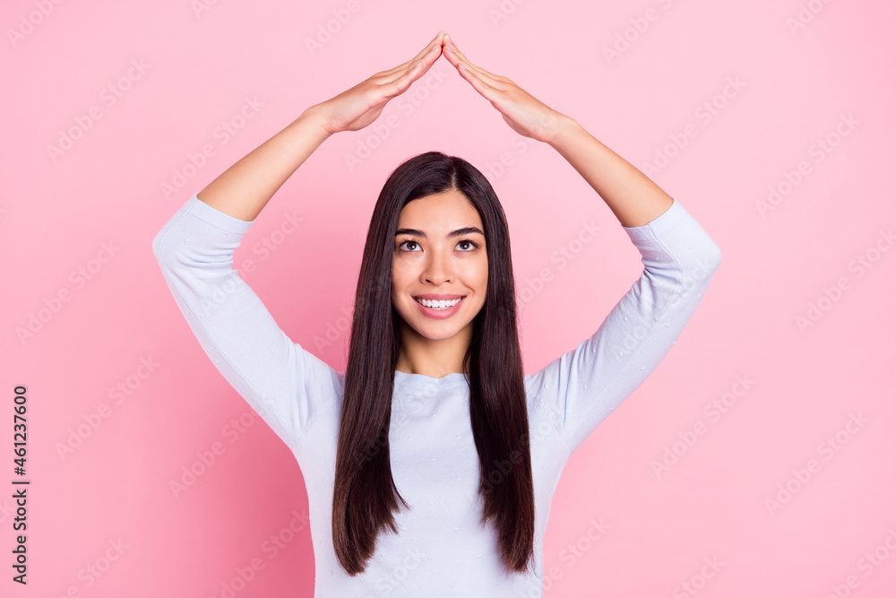 Photo portrait of girl smiling feeling safe looking up isolated on pastel pink color background Photo portrait of girl smiling feeling safe looking up isolated on pastel pink color background