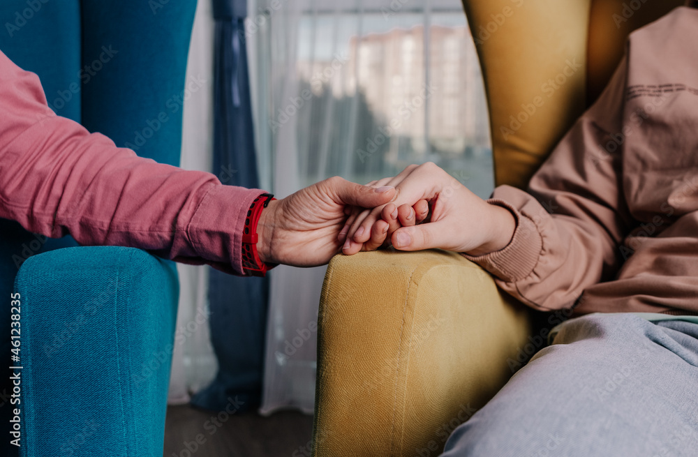 Fototapeta premium close-up of clasped hands in a gesture of support