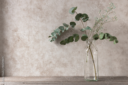 Bilde på lerret eucalyptus green branches in a vase on a wooden shelf, daylight, interior design