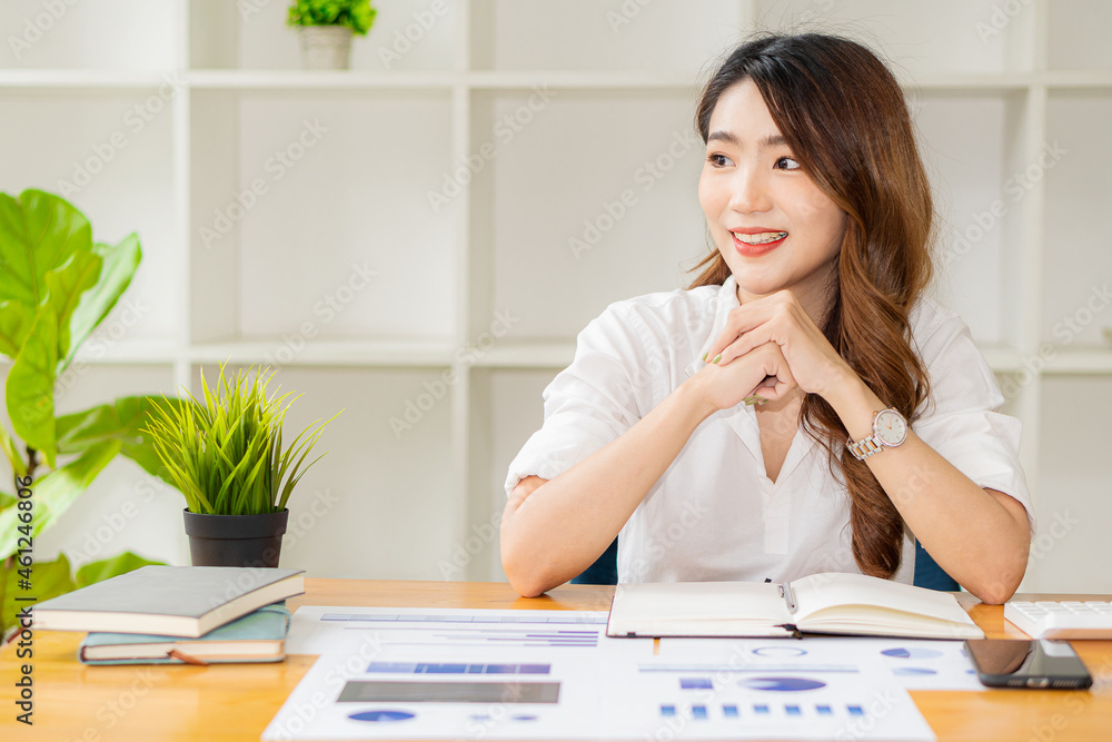 Businesswoman analyzing and brainstorming data, charts, financial reports in the office with laptop and calculator. Ideas for working with financial and investment accounts. Businesswoman analyzing and brainstorming data, charts, financial reports in the office with laptop and calculator. Ideas for working with financial and investment accounts.