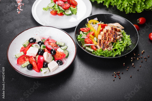 different types of salads on the table menu vegetables, meat, salad fresh portion ready to eat meal snack copy space food background rustic. top view keto or paleo diet