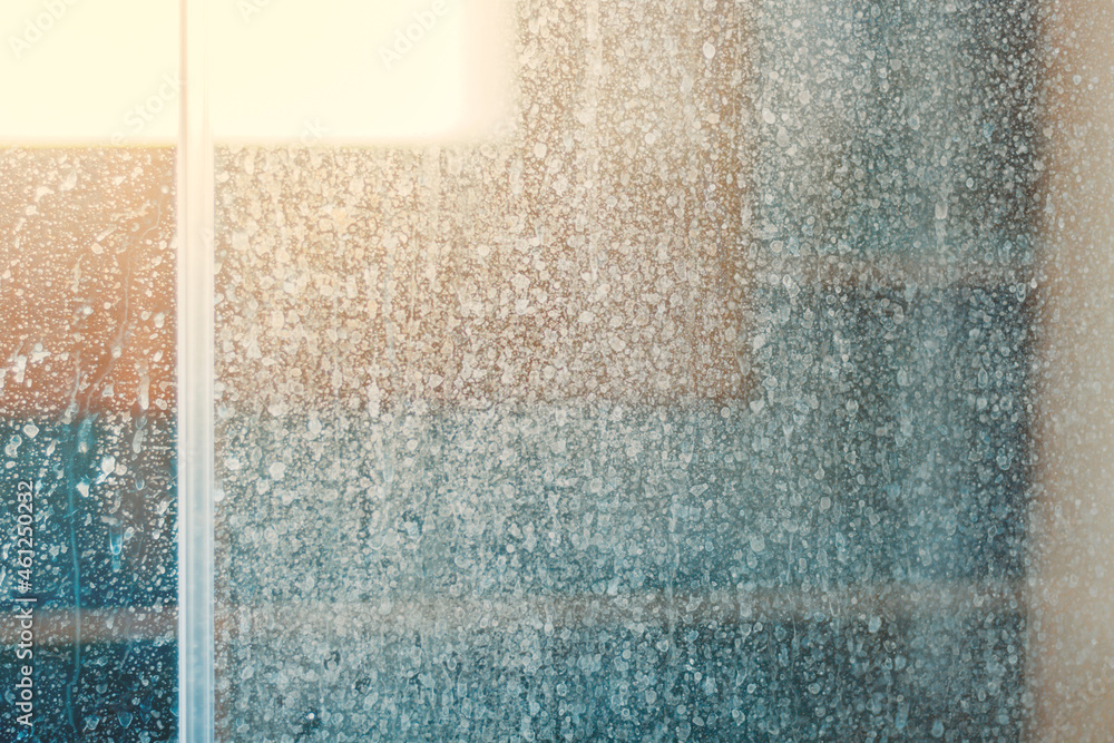Removing hard water stains and deposits in bathroom. Stains drops on glass shower doors - obrazy, fototapety, plakaty 
