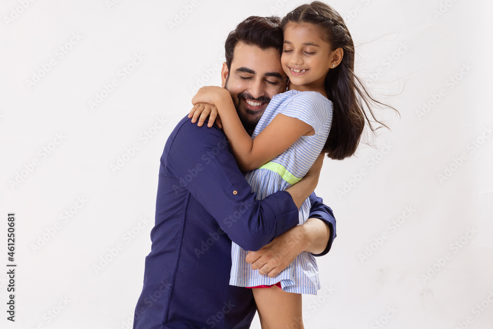 A HAPPY FATHER AND DAUGHTER EMBRACING EACH OTHER