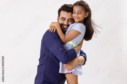 A HAPPY FATHER AND DAUGHTER EMBRACING EACH OTHER