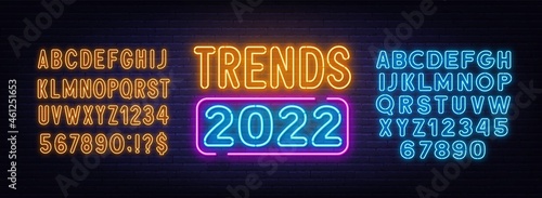 Trends 2022 neon sign on brick wall background.