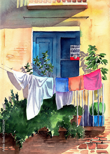 Watercolor illustration of a sun-drenched house facade with a balcony entwined with greenery, flower pots, a turquoise wooden door and linen hung on a clothesline 