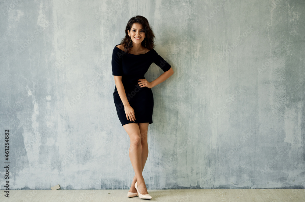 pretty brunette in black dress near the wall posing luxury pretty brunette in black dress near the wall posing luxury