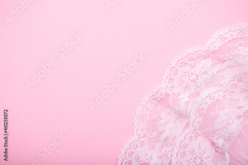 Beautiful gentle pink background made of lace female underwear with room for text. erotic underwear