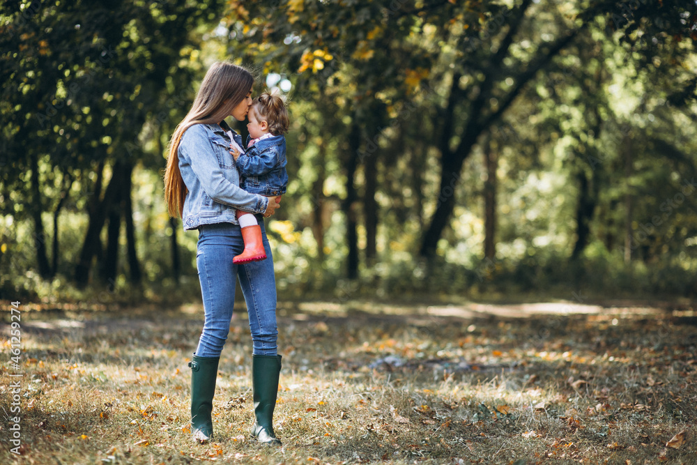 Young mother with her little daughter in an autumn park Young mother with her little daughter in an autumn park