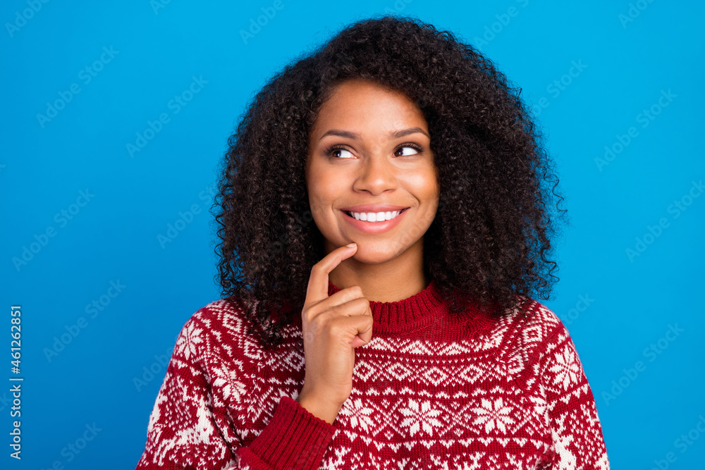 Photo of thoughtful charming lady wear print pullover finger chin looking empty space smiling isolated blue color background Photo of thoughtful charming lady wear print pullover finger chin looking empty space smiling isolated blue color background