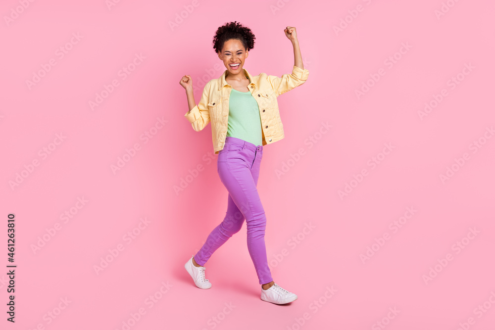 Full length body size view of attractive cheerful girl going rejoicing having fun isolated over pink pastel color background Full length body size view of attractive cheerful girl going rejoicing having fun isolated over pink pastel color background