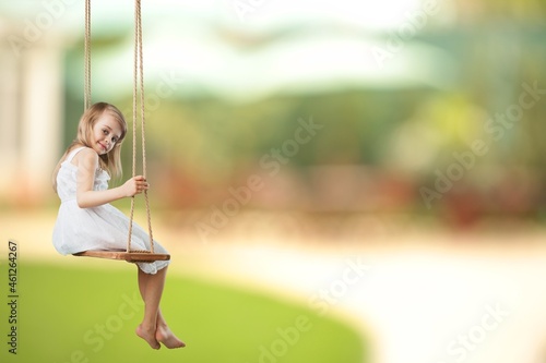 Little boy having fun on a playground in public park on autumn day.